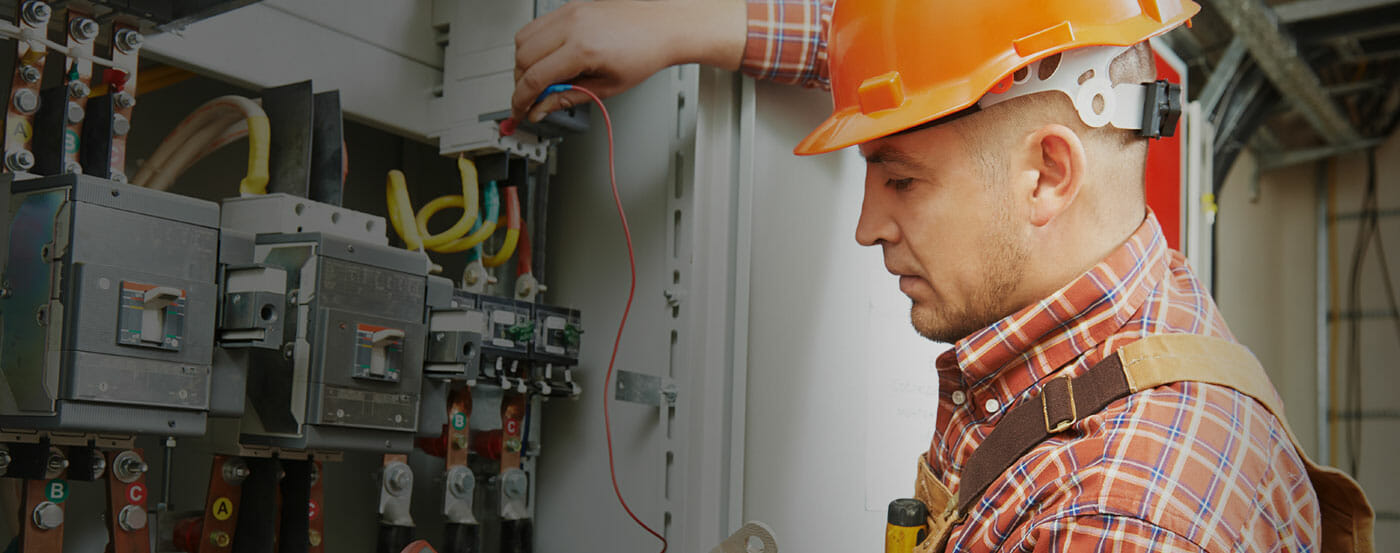 Technician working on an electrical panel