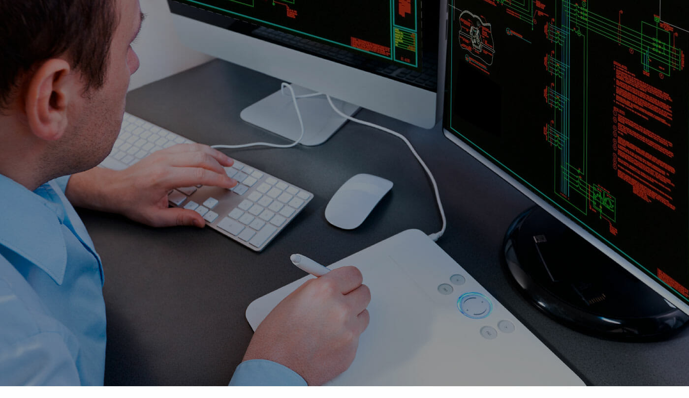 man working at a computer with a graphics tablet