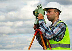 Photo of a worker operating a optical level