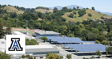 Solar canopy covering a parking lot in a tree lined area